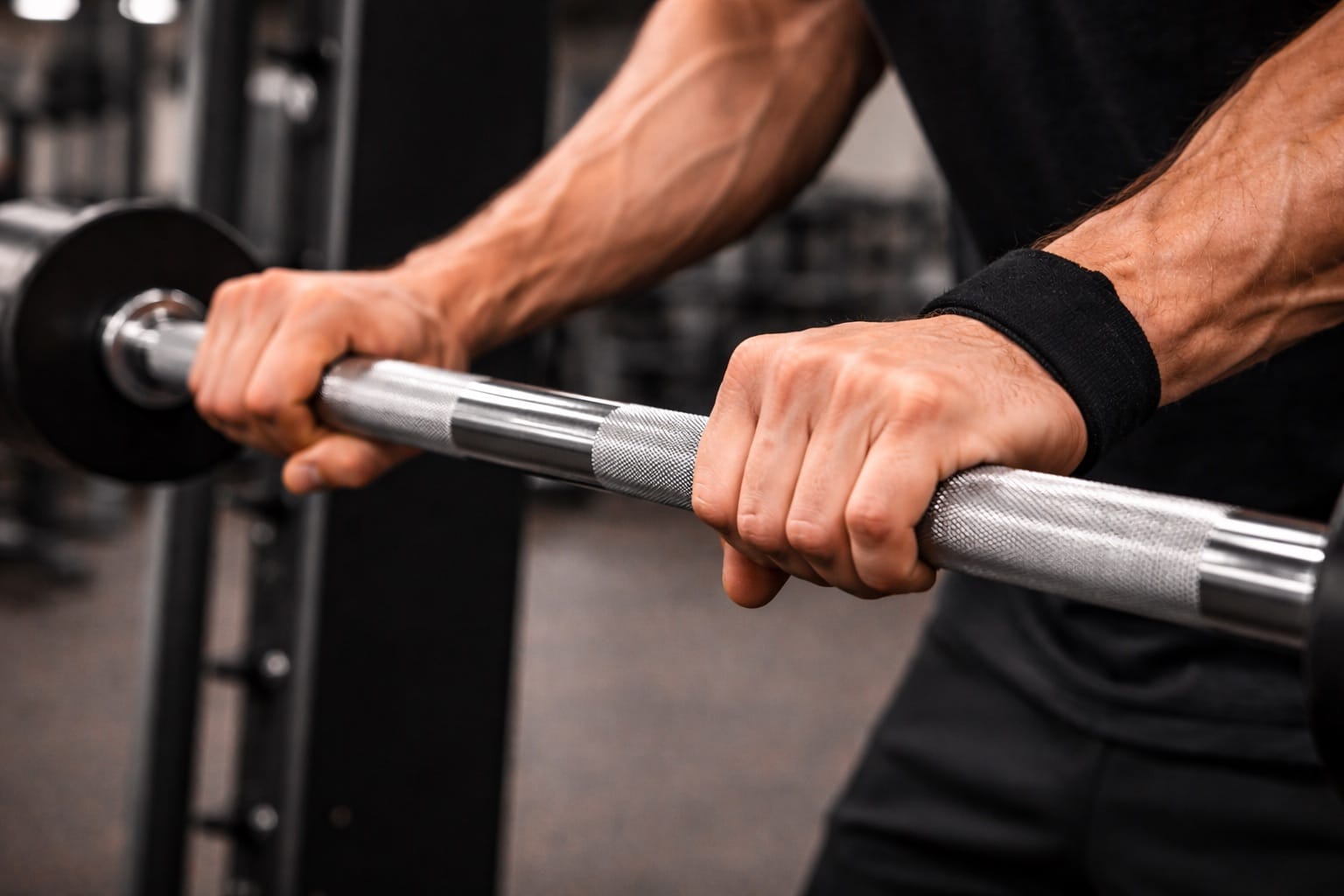 Hands gripping a barbell demonstrating proper grip technique