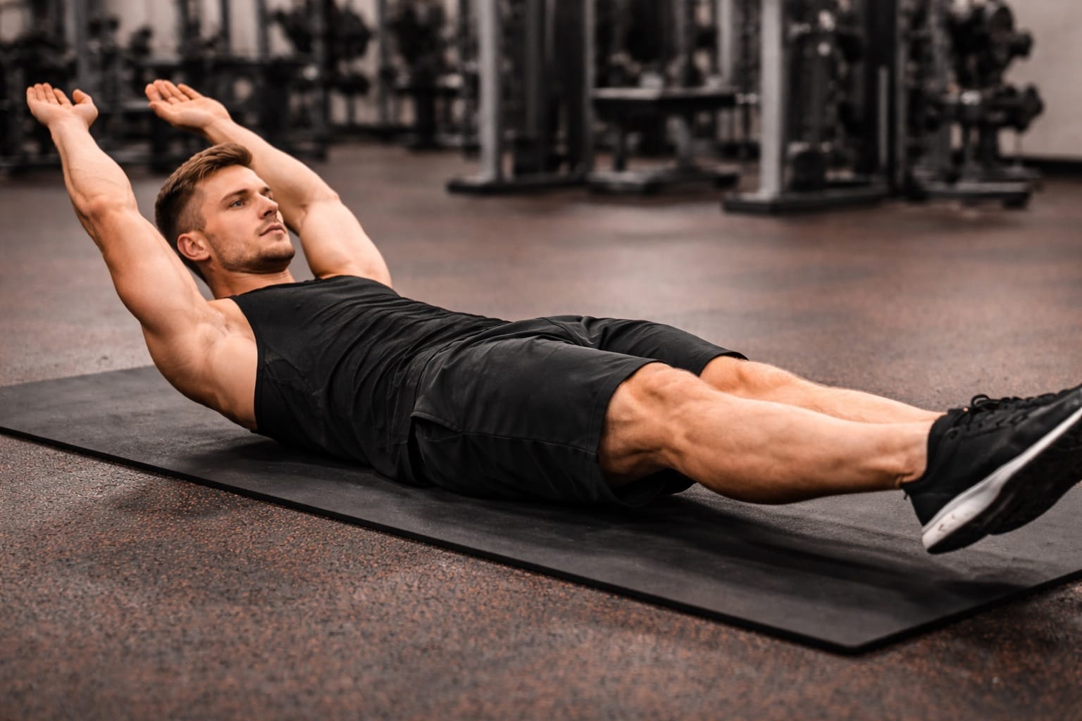 Athlete performing a challenging core exercise on a gym floor