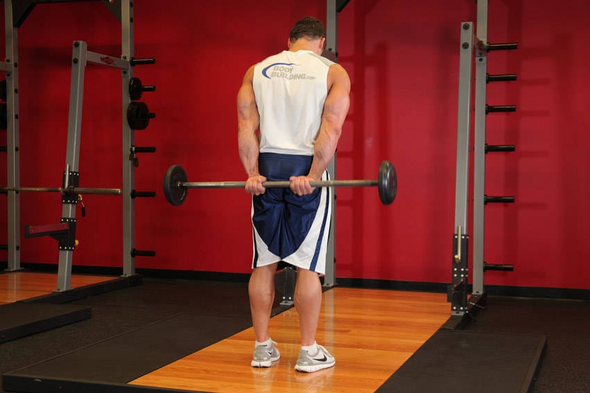Standing Palms-Up Barbell Behind The Back Wrist Curl - Step 0